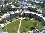 Today’s crescent courtyard closely resembles the 1962 original. However, the moatlike edges have been rebuilt to include skylights that illuminate the activity areas extending under the lawn.