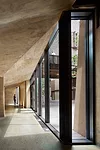 KTA designed the underground areas to receive ample light through a sunken courtyard and glazed walls, while giving circulation areas architectural expression with sloping concrete ceilings.