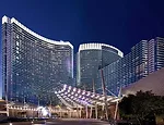 The edges of sunshades on the sawtooth-shaped facade of the Aria Resort & Casino catch light from floodlights placed on the hotel's vast podium. These lights, together with fluorescent fixtures illumi