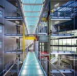 A series of glass bridges, backlit by lines of T5 lamps, link office spaces.