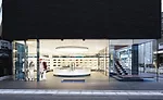 Made of a translucent formable material supported by a polished stainless steel frame, the shop&rsquo;s oversize elliptical luminaire hovers above a glowing cash/wrap station and illuminates the acces