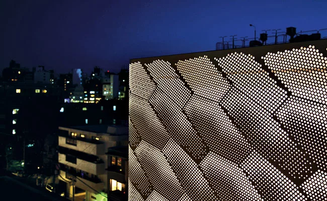 Stacked horizontally, three levels of different materials &mdash; glass, terra-cotta, and punched anodized aluminum panels &mdash; define the exterior of the 2,800-square-foot boutique.