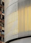 Backlit by fluorescent lamps and easily reached between the product walls and existing glazing, a new perforated metal skin reveals a pattern reminiscent of rippled fabric.
