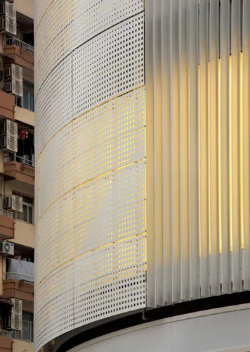 Backlit by fluorescent lamps and easily reached between the product walls and existing glazing, a new perforated metal skin reveals a pattern reminiscent of rippled fabric.