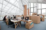 Employees sitting at workstations designed by Frank Gehry are protected from the sun&rsquo;s glare by a sophisticated system of saillike shades, controlled by daylight sensors. Artemide Tolomeo desk l
