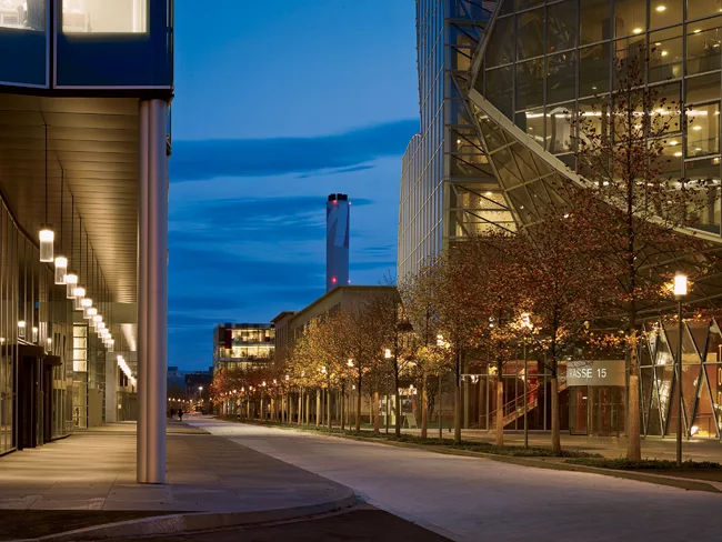 The master plan and exterior lighting scheme of the Novartis Campus in Basel comprise unifying design elements such as an arcade (left) and simple, custom light fixtures created from a functional desi