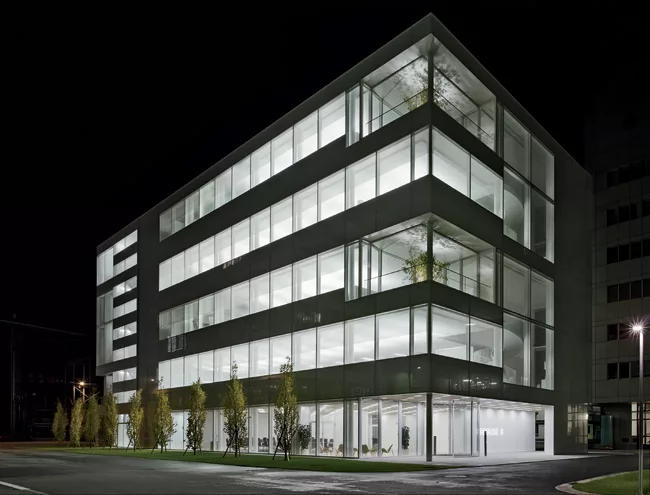 Opening onto a campus square (under construction), the ground level of Fumihiko Maki’s Square 3 office building features warm tones to provide a natural transition from the future green space ou