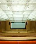 L'Observatoire installed cool white fluorescent lamps above the auditorium's glass ceiling that blend imperceptibly with the daylight coming into the space from a skylight above the stage that Gehry i