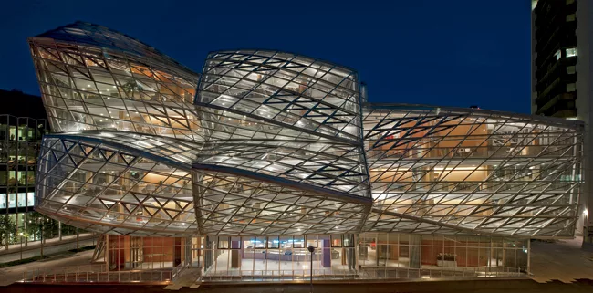 Completed in 2009, Frank Gehry&rsquo;s Fabrikstrasse 15 is an icon on the growing Novartis Basel campus. In the evening its brilliant sculptural form is underscored by layers of light ' all on the int