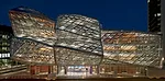 Completed in 2009, Frank Gehry&rsquo;s Fabrikstrasse 15 is an icon on the growing Novartis Basel campus. In the evening its brilliant sculptural form is underscored by layers of light ' all on the int