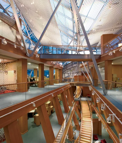A central atrium brings daylight to interior Gehry-designed workstations and glass-enclosed &ldquo;private rooms&rdquo; at the heart of the office floors. Adjustable metal-halide up and downlights ill