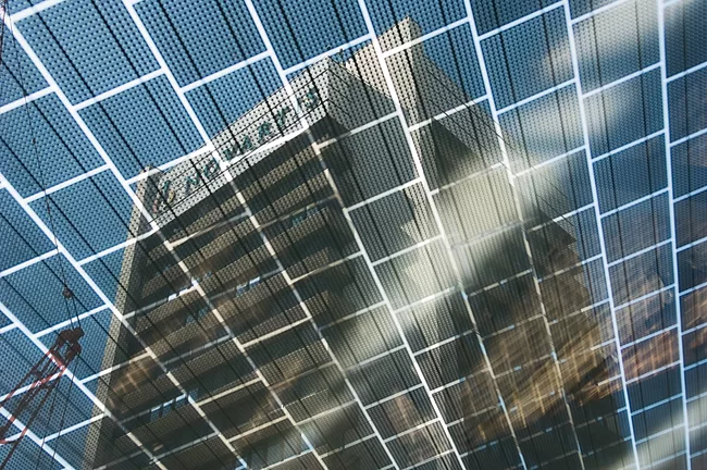 Photovoltaic cells are integrated in the glass roof surfaces to generate renewable energy for the electrical lighting and to provide an effective sunscreen against solar gain in upper levels of the bu