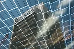 Photovoltaic cells are integrated in the glass roof surfaces to generate renewable energy for the electrical lighting and to provide an effective sunscreen against solar gain in upper levels of the bu