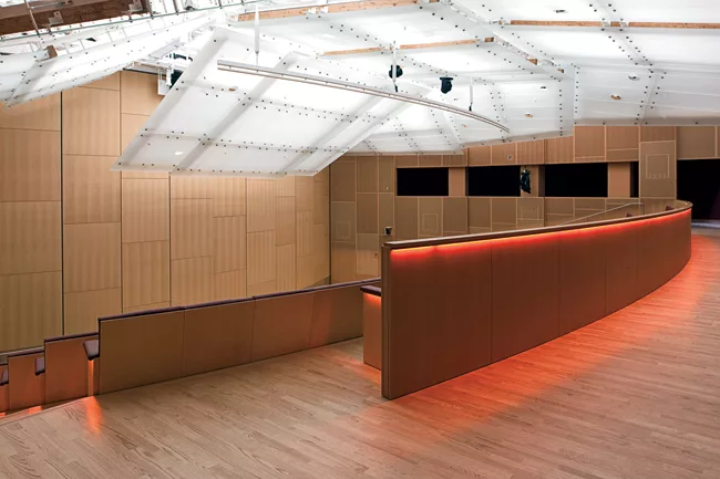 Below grade, a 600-seat auditorium can be divided into two sections. It features: a wood-lined acoustical wall perforated with a subtle graphic pattern by the New York'based graphic design firm 2x4; a