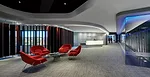 Upon entering the lobby of the Southfield MTC, visitors are immediately drawn to the luminous solid-surfacing reception desk, lit with LEDs. Wooden louvers allow daylight in or block it out, as needed