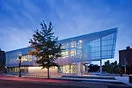 T5 uplights inside the building on top of exposed beams and carrels beneath clerestory windows provide well-balanced, ambient illumination inside and also create a glowing, lanternlike effect for pass