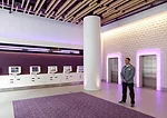 In the lobby, white LEDs wash a textured wall. Purple LEDs illuminate elevator door surrounds.