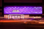 A strip of linear LEDs installed at the top and bottom of precast-concrete facade panels emphasize the cladding's relief pattern.