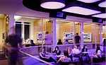 The Rockwell Group'designed Yotel has a daytime meeting room that transforms into a bar at night. To accommodate both uses, ceiling panels backlit with color-changing LEDs can fill the space with eith