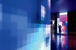 The interactive work enlivens the lobby of a busy civic building and bounces its vivid hues off the surfaces of the floor and ceiling.
