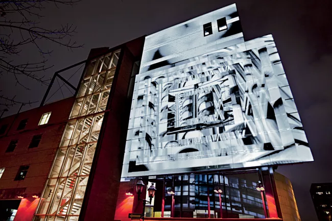 Rinfret’s illuminations reflect an exhibition of the Montreal architect Norman Slater's works on a preexisting skin of the Design Center.