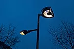 Shadow play Custom fixtures at the tops of the poles (left) face away from the street and house a series of mirrors and projectors that distribute a playful array of vertical and horizontal light patt