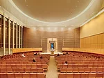The architects and lighting designers collaborated to create a custom wood screen for the east-facing window wall behind the ark that delivers a subtle, filtered light during the day (slide 2) and an 