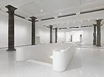 The architects transformed the original building's basement into an event mezzanine, the Metzler-Foyer, and created an elegant concrete stair to lead visitors to the Garden Hall.