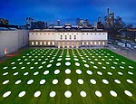 A mix of warm and cool LEDs in the skylights illuminate the grounds above the St'del extension in the evening.