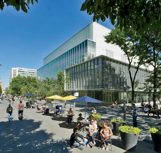 Wrapped in fritted, low-iron glass, the building is pristine by day, a serene backdrop for the pedestrian plaza, once a vehicular route.