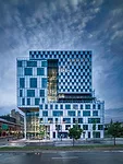 To connect these spaces, the architects created a central atrium with glazing on the north-south axis and fixed louvers on the south side (shown) to minimize heat gain.