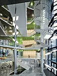 The atrium receives daylight through its glazed exterior walls and a modest skylight.