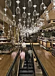 A luminous installation at Hedonism Wines comprises inverted sommelier glasses tipped with LEDs at the base of their stems.