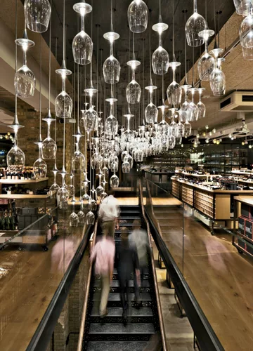 A luminous installation at Hedonism Wines comprises inverted sommelier glasses tipped with LEDs at the base of their stems.