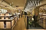 Inside the entrance, a champagne-hued material palette sparkles by the light of delicate, bubblelike glass pendants and the sommelier-glasses &ldquo;chandelier.&rdquo;