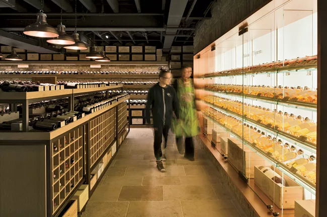 The cavelike lower level features a storage unit specially lit to highlight the shop’s collection of vintage Château d’Yquem.