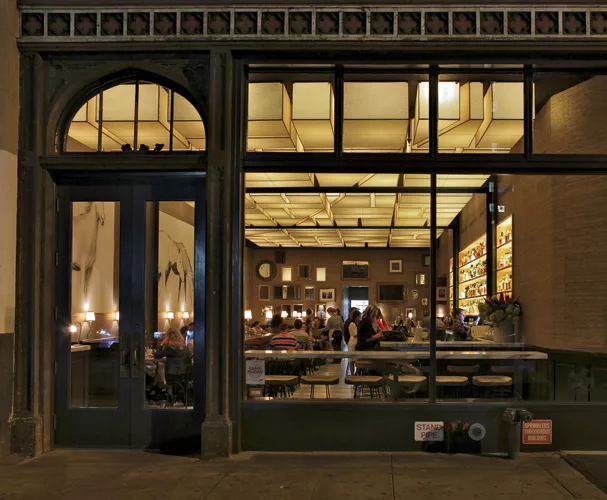 The ceiling matrix), designed by the architects, was based on aerial views of Kentucky cornfields. Made of Mylar-backed oiled craft paper on steel frames, the 18-inchhigh shades are spaced 4 inches ap