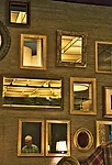 The private dining area (slide 2) features a wall grid inset with a playful mix of mirrors and windows. These either reflect the barrel shades within the room or provide glimpses of the ceiling grid&m