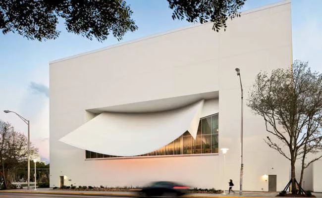On the center's north wall, a white plastered shotcrete sunshade shields the performance hall from glare. Two layers of laminated insulated glass separated by a 3-foot air space eliminate outdoor nois