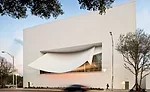 On the center's north wall, a white plastered shotcrete sunshade shields the performance hall from glare. Two layers of laminated insulated glass separated by a 3-foot air space eliminate outdoor nois