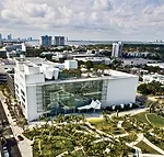 The center's entrance facade overlooks Miami Beach Soundscape, a park designed by West 8. To the side of the entrance is a 7,000-square-foot projection wall of smooth plaster on metal studs that displ