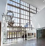 The atrium, featuring Frank Stella's bent tube sculpture Taboehan (2003), includes a lobby with a box office marked by a 17-foot-long plasma wall that announces the center's programs. 