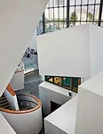 In the six-story atrium, Gehry stacked geometric forms for various functions. Most contain rehearsal rooms where viewers can glimpse musicians at work.
