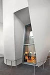 The clustered volumes are constructed from a curved steel stud track system surfaced with as many as five layers of drywall.
