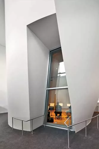 The clustered volumes are constructed from a curved steel stud track system surfaced with as many as five layers of drywall.