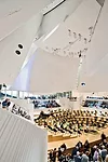 Daylight can enter the performance hall from the north window behind the 50-foot-high stage. 'Sails' of curved, layered drywall over 2-inch shotcrete create a surface mass and add to the luminous ambi