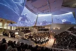 The flexibility in the 756-seat hall is accomplished by 14 configurations of the stage, 247 seats that retreat to a flat floor, 10 mechanical stage lifts, and four satellite platforms. Five 'sails,' s