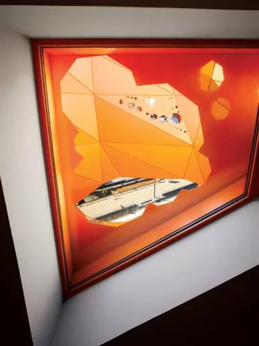 The building's bold color was inspired by the site's past: orange 'safety' paint is often used in industrial zones. Irregular cutouts lend a whimsical touch to the building.