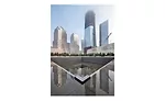 Water around and in the memorial pools reflects the skyline of Lower Manhattan without the Twin Towers.