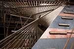 The formwork for the twisting Lightfall consisted of three layers: curved spruce planks assembled in a fashion similar to shipbuilding, sheets of bent plywood, and steel tubes welded together in a fan